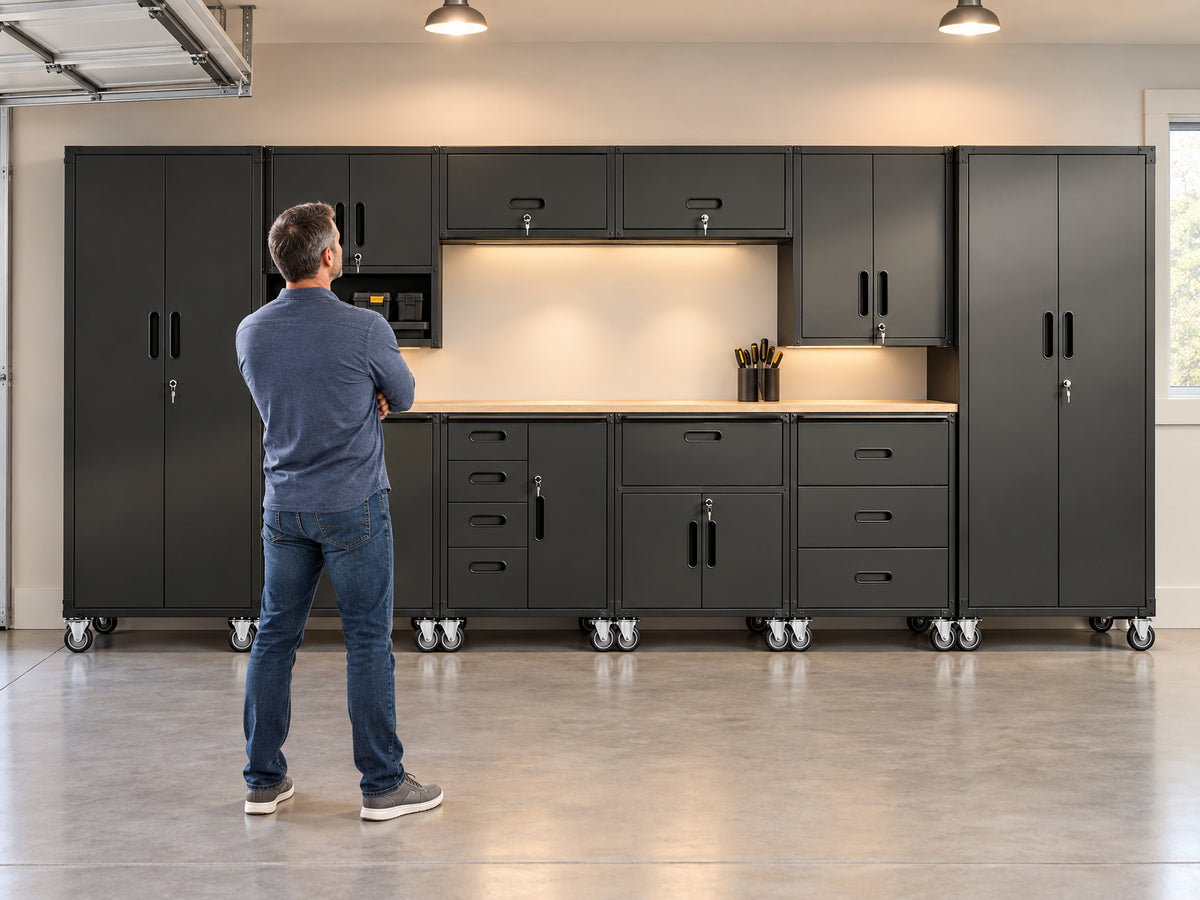 10-Piece Heavy Duty Steel Garage, man stands with arms crossed, facing the full wall of cabinets